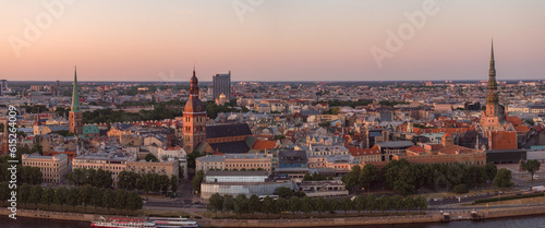 RIga rooftop view panorama at sunset with urban architectures and Daugava River. Aerial view of the Riga old town at sunset.