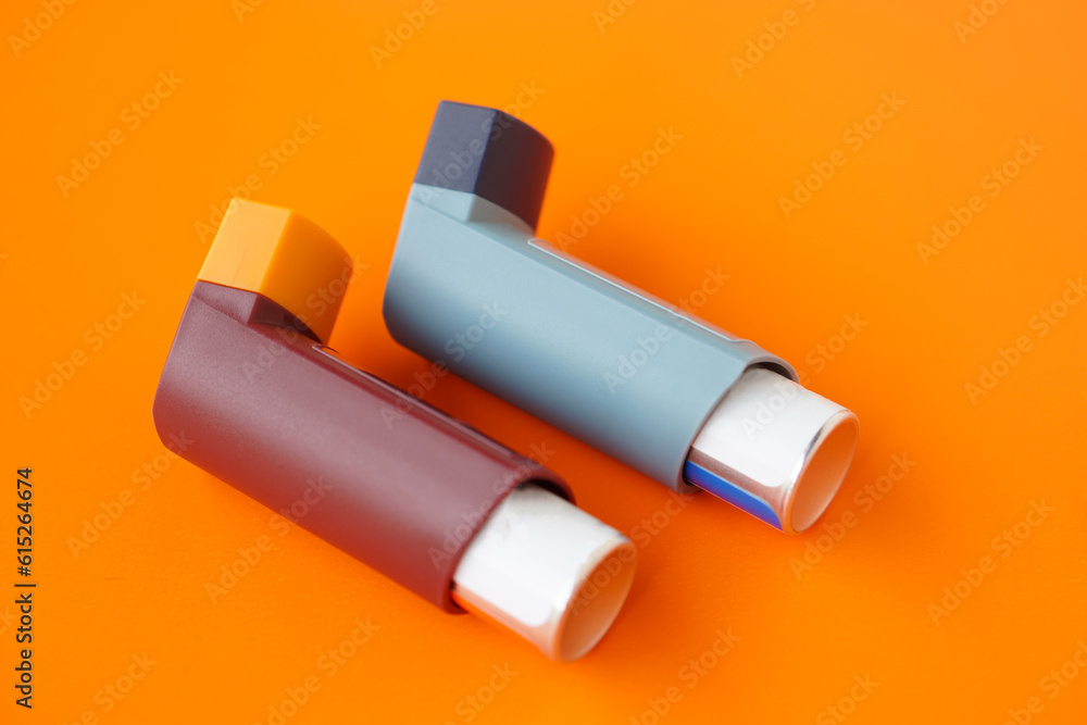 Asthma inhalers on orange background. Concept, Pharmaceutical products