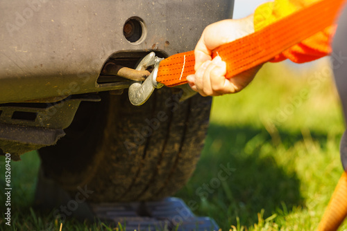 Male hand attaching towline to car photo