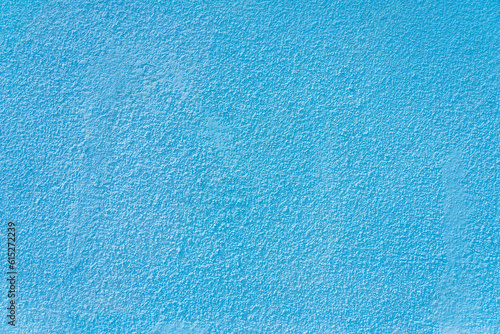 Rough textural surface of a blue wall. Background or backdrop. Blank for design