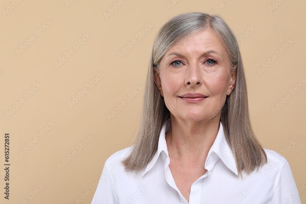 Portrait of beautiful senior woman on beige background. Space for text Portrait of beautiful senior woman on beige background. Space for text