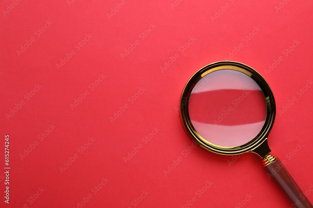 Magnifying glass on red background, top view. Space for text Magnifying glass on red background, top view. Space for text