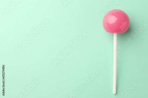 Tasty lollipop on turquoise background, top view. Space for text © New Africa