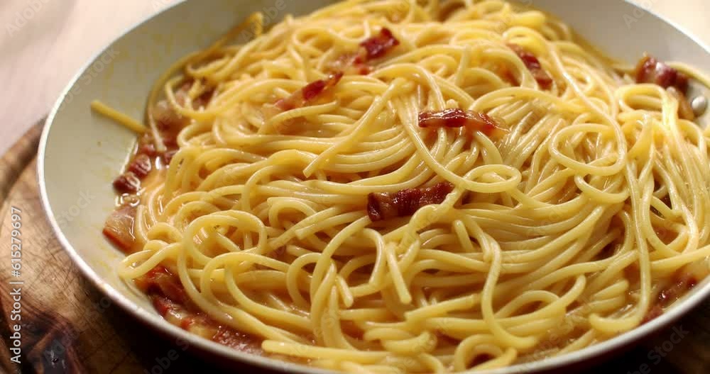 Spaghetti carbonara. Pasta with pancetta, egg, parmesan cheese. Slider shot. Smooth camera movement. Traditional italian cuisine. Pasta alla carbonara. 4k footage. Spaghetti carbonara. Pasta with pancetta, egg, parmesan cheese. Slider shot. Smooth camera movement. Traditional italian cuisine. Pasta alla carbonara. 4k footage.