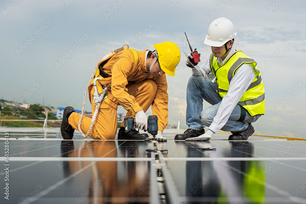 Engineers check the installation of solar panels on the factory roof, command engineers, supervise the installation of solar panels, engineers and technicians check the operation of solar panels. Engineers check the installation of solar panels on the factory roof, command engineers, supervise the installation of solar panels, engineers and technicians check the operation of solar panels.