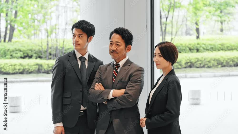 Group of various generation Asian businesspeople standing in lobby. Company employees who challenge for success. Group of various generation Asian businesspeople standing in lobby. Company employees who challenge for success.