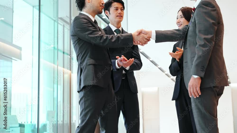 Group of businessperson shaking hands in office lobby. Success of business. Deal. Cooperation. Group of businessperson shaking hands in office lobby. Success of business. Deal. Cooperation.