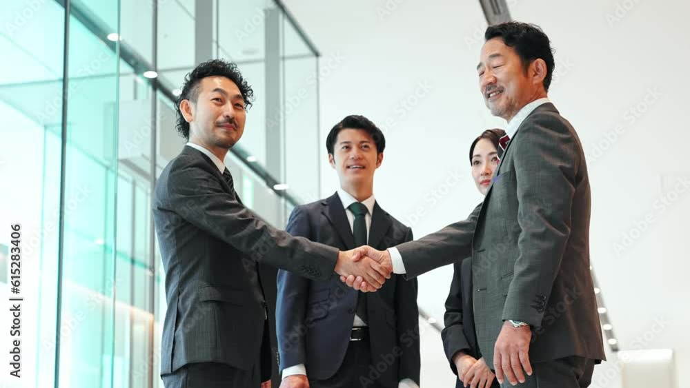 Group of businessperson shaking hands in office lobby. Success of business. Deal. Cooperation. Group of businessperson shaking hands in office lobby. Success of business. Deal. Cooperation.