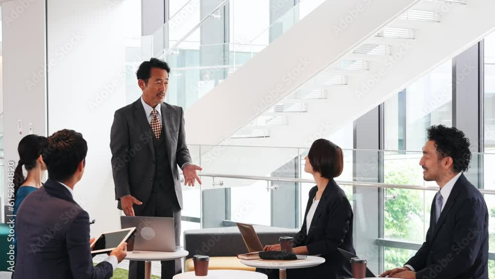 Group of various generation Asian businesspeople meeting in lobby. Office workers discussing for success. Group of various generation Asian businesspeople meeting in lobby. Office workers discussing for success.