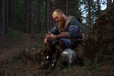 Medieval warrior viking barbarian with ax and shield in forest