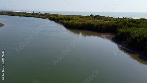 Cinematic aerial view flying above River Gambia to reveal the Atlantic Ocean photo