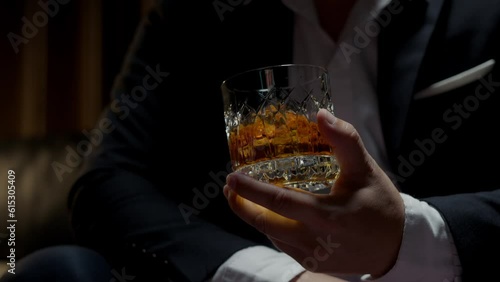 businessman holding whiskey, a restaurant