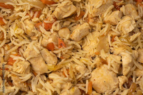 Tasty pilaf with chicken as background.