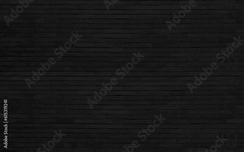 Gloomy background, black brick wall of dark stone texture. Dark black brick wall Is the background of the room that has textures Of old antique plaster grunge