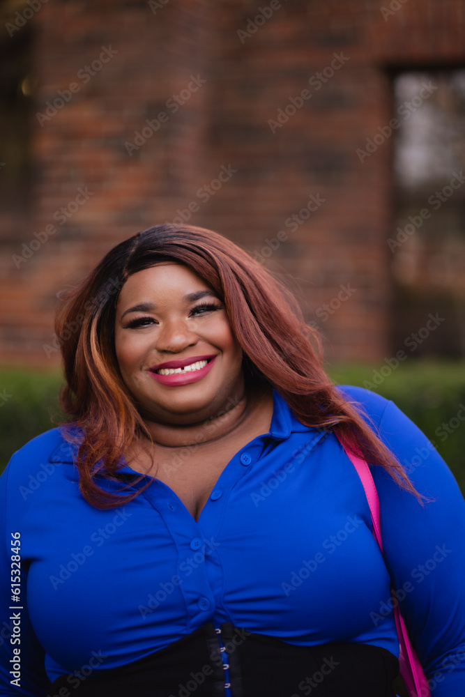 A happy portrait of a smiling college-age woman outside an old library. A happy portrait of a smiling college-age woman outside an old library.