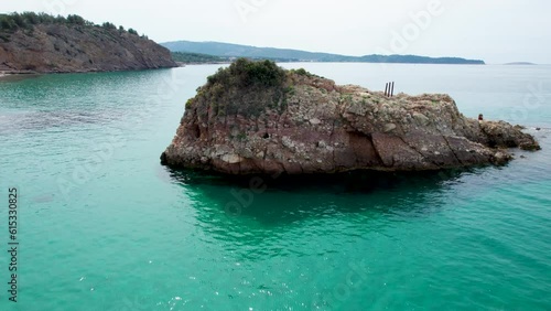 Rotating Aerial View Near Metalia Beach With Turquoise Water And A Small Rocky Island, Thassos, Greece, Europe photo