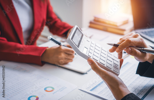 Close up hand young businesswoman calculating  working on desk office with the chart graph financial account