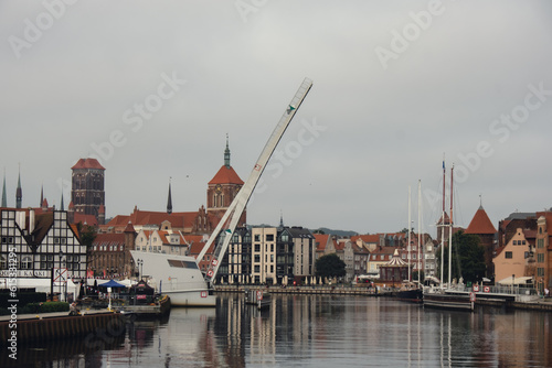 Gdansk city from ship view. Amazing cityscape of Gdansk over Motlawa river. Travel touristic attraction ship. Ship goes to island Hel Old town in Poland