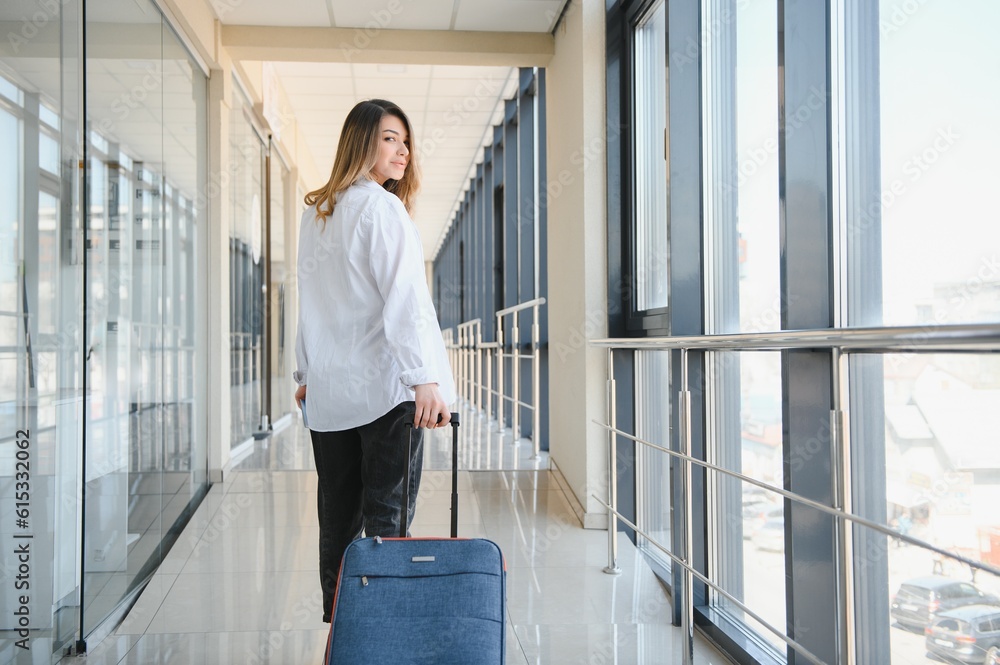 Happy woman traveling and walking in airport Happy woman traveling and walking in airport
