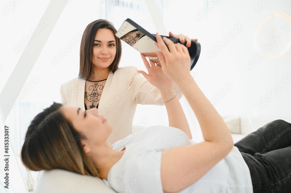 Portrait of a beautiful woman, her lips are painted with pink lipstick, looking in the mirror. Portrait of a beautiful woman, her lips are painted with pink lipstick, looking in the mirror.