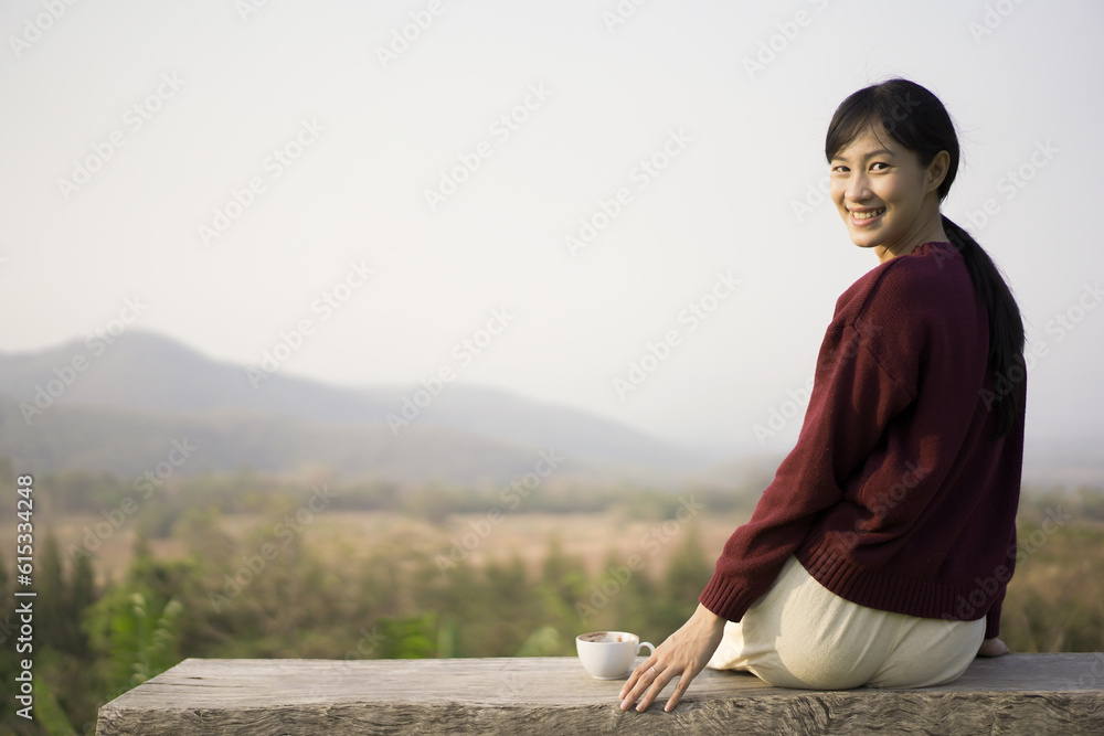 Beautiful Asian young woman holding a coffee cup on a hands close up. Woman enjoy drinking a coffee in morining with breakfast. Beautiful Asian young woman holding a coffee cup on a hands close up. Woman enjoy drinking a coffee in morining with breakfast.