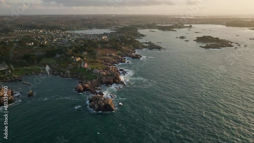 Wide Fly-Away shot of Phare Du Mean Ruz Lighthouse in Bretagne France during sunset photo