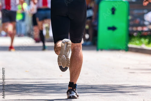 The legs of an athlete running on the asphalt marathon distance
