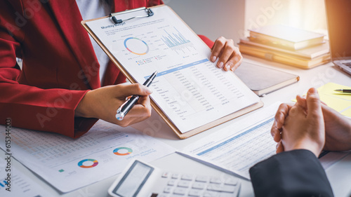Businesswoman working in office, report papers , financial chart analysis company financial budget report with calculator and accounting financial statement planning.