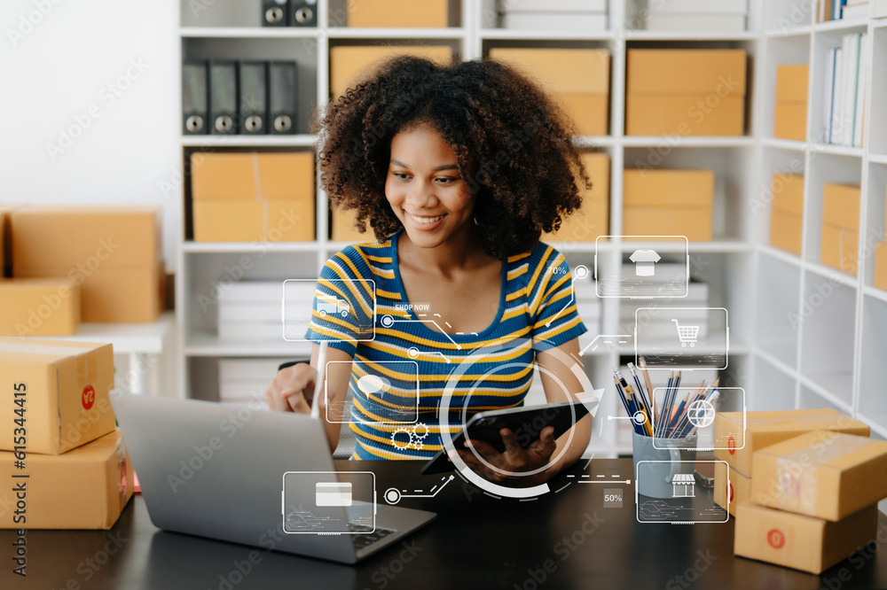 African Woman hand using a laptop, smartphone and tablet and writing notebook at the office of her business online shopping. In home with virtual icon African Woman hand using a laptop, smartphone and tablet and writing notebook at the office of her business online shopping. In home with virtual icon