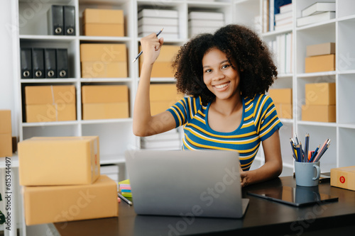 Small business entrepreneur SME freelance African woman working at home office, BOX,tablet and laptop online, marketing, packaging, delivery,  e-commerce concept © Nuttapong punna