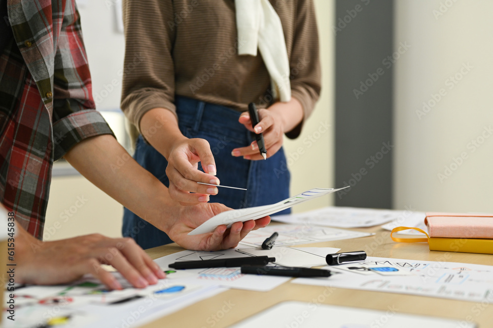 UX designer team working on new website wireframe, planning application development for web mobile phone at co working space UX designer team working on new website wireframe, planning application development for web mobile phone at co working space