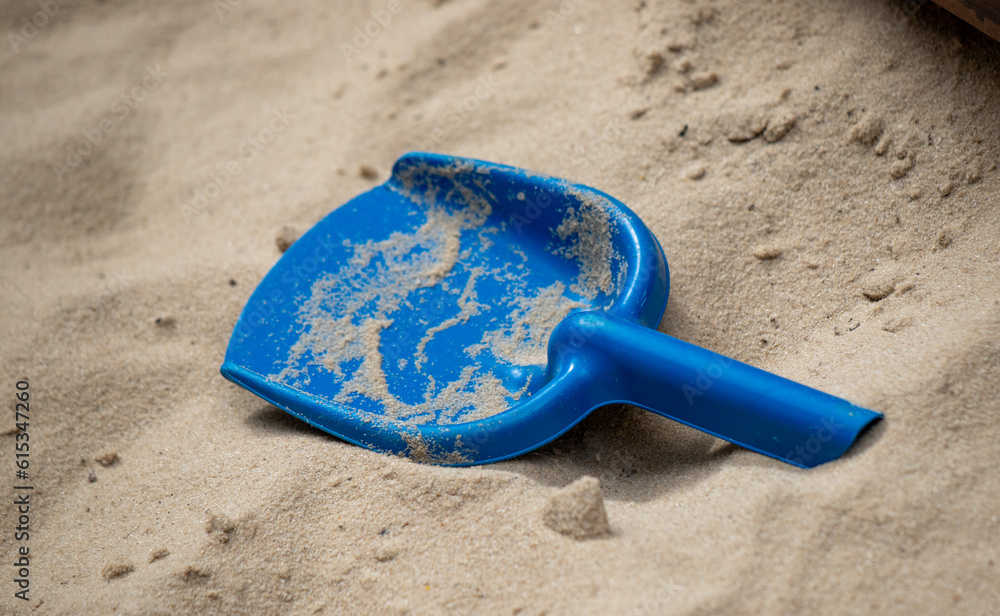 children's plastic toys on yellow sand children's plastic toys on yellow sand
