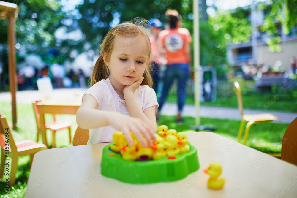 Adorable preschooler girl playing board game Adorable preschooler girl playing board game