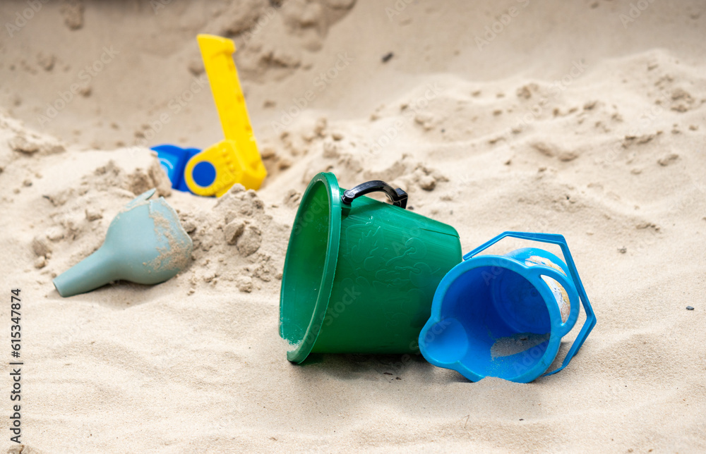 children's plastic toys on yellow sand children's plastic toys on yellow sand