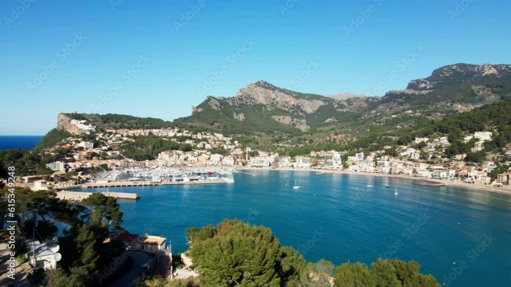 Full panning shot of entire Port Soller Bay on tropical Spanish island Mallorca with luxury Mega Yachts and Villas. Aerial shot of ocean and mountains. Full panning shot of entire Port Soller Bay on tropical Spanish island Mallorca with luxury Mega Yachts and Villas. Aerial shot of ocean and mountains.