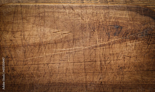 Brown scratched wooden cutting board. Wood texture