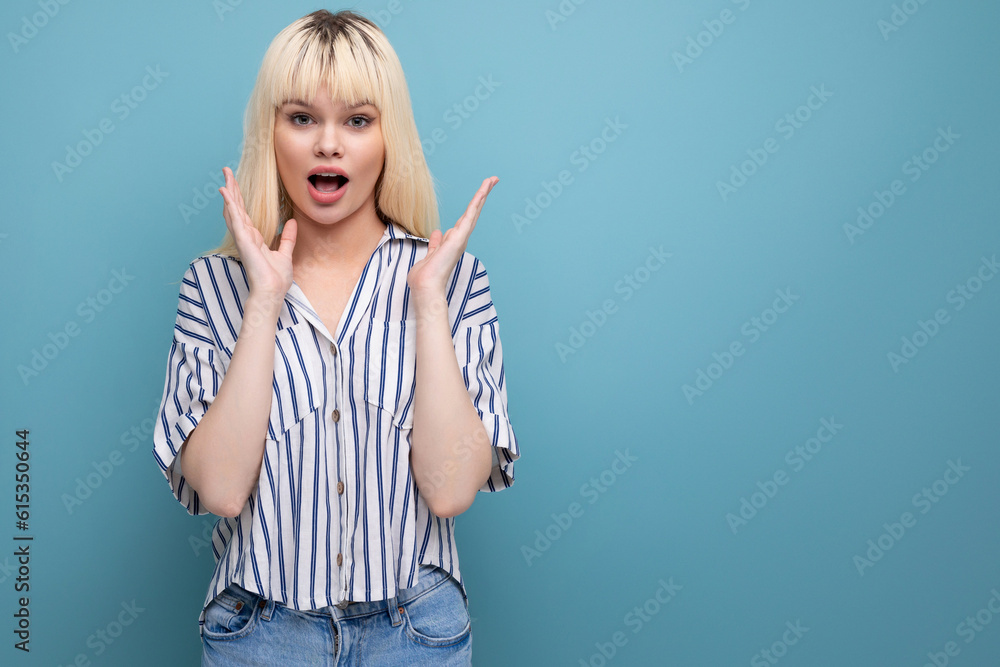 surprised blond young lady in casual outfit in studio surprised blond young lady in casual outfit in studio