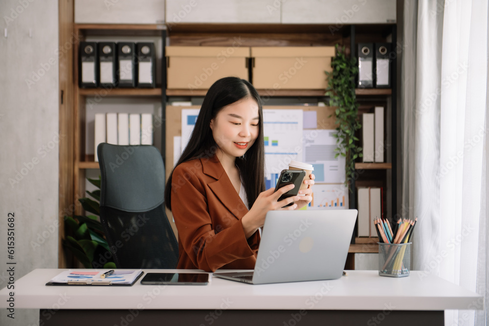 Asian young businesswoman working in the office with working notepad, tablet and laptop documents Asian young businesswoman working in the office with working notepad, tablet and laptop documents