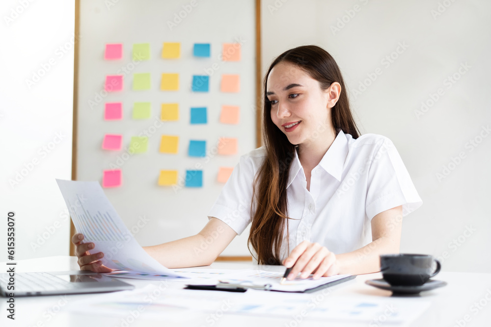 Asian businesswoman sit at their desks and calculate financial graphs showing results about their investments, planning successful business growth process