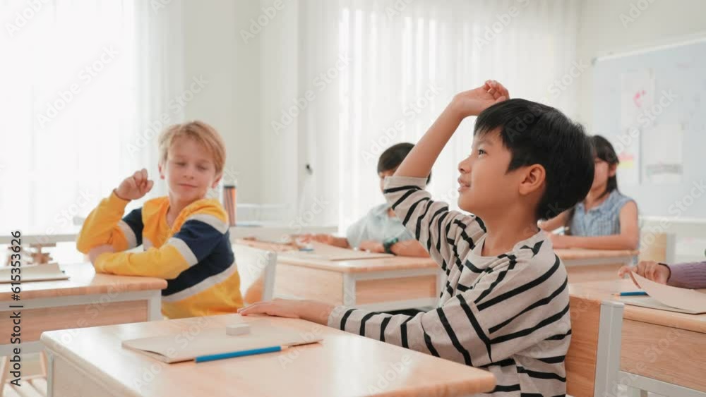 Group multi ethnic children raise hand to answer the teacher question in classroom at elementary School, Student Learning and educational concept Group multi ethnic children raise hand to answer the teacher question in classroom at elementary School, Student Learning and educational concept