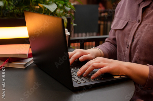 Wallpaper Mural Female hands on keyboard, woman working on a laptop at the table in cafe Torontodigital.ca