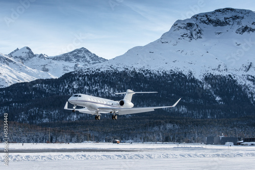 Luxury private jet approaching the engadin valley in the Swiss alps. This mountain resort is visited by many rich people during their winter vacations.	
