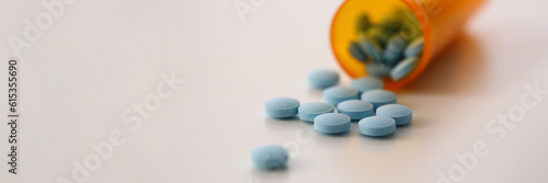Photography Medical round blue pills bottle with pills on table