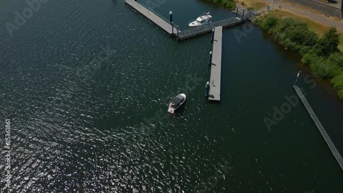 Aerial birdseye shot of De Grote Hegge in Thorn, Maasgouw in the province of Limburg overlooking the calm lake with a jetty and boat in the water photo