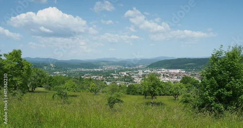 Die Stadt Lörrach aus Tullinger Berg und Streuobstwiesen. Blick auf die Innenstadt Richtung Nordosten, Wiesentalbrücke, Brombach und Südschwarzwald am Horizont photo