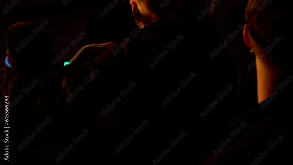 Portrait of attractive female techno DJ performing playing her music set on a stage in front of crowd in a nightclub during a festival, bright flashing stage lights, huge LED screen behind talent Portrait of attractive female techno DJ performing playing her music set on a stage in front of crowd in a nightclub during a festival, bright flashing stage lights, huge LED screen behind talent