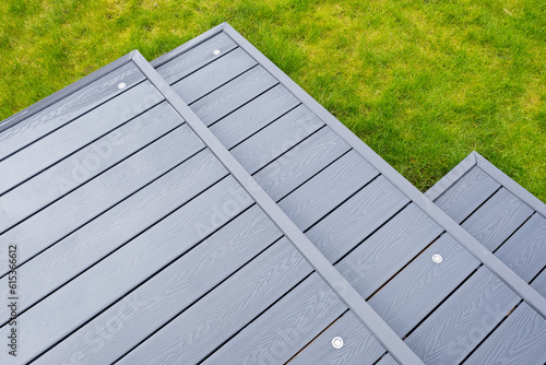 Schilderij op canvas Ash grey composite decking on a rainy wet day showing the full grain of the deck