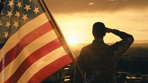 American soldier salutes sunset