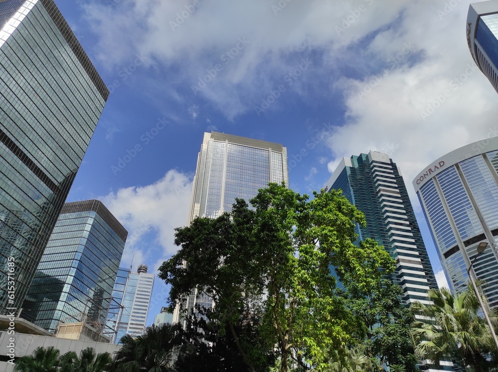 Low angle view of buildings in Hong Kong city against sky 