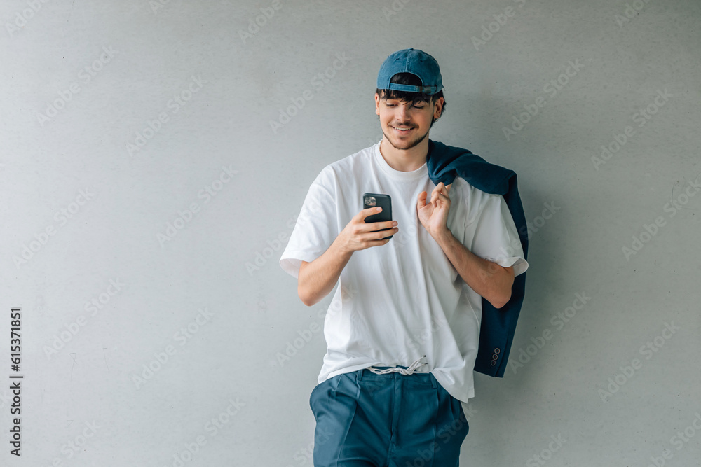 portrait of young male with cap looking at mobile phone portrait of young male with cap looking at mobile phone